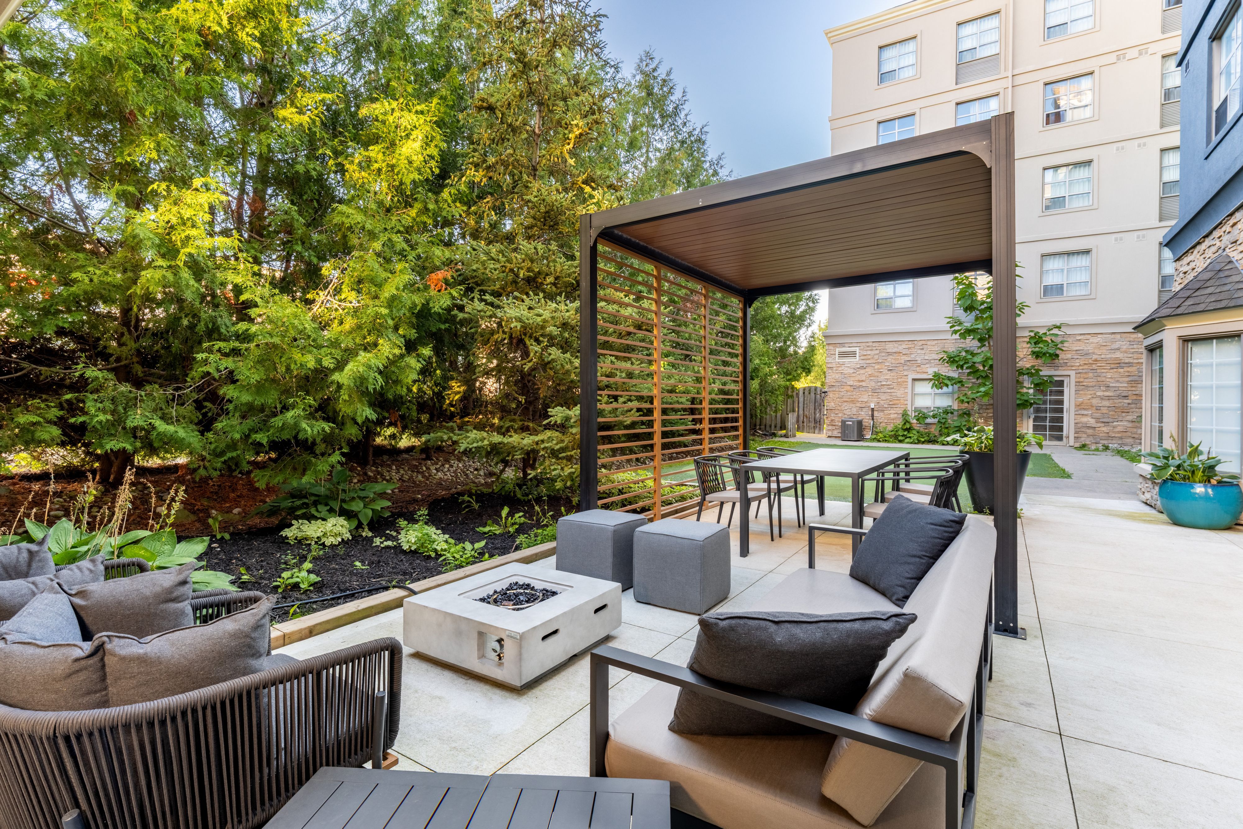 image Outdoor lounge area with fire pit and seating.