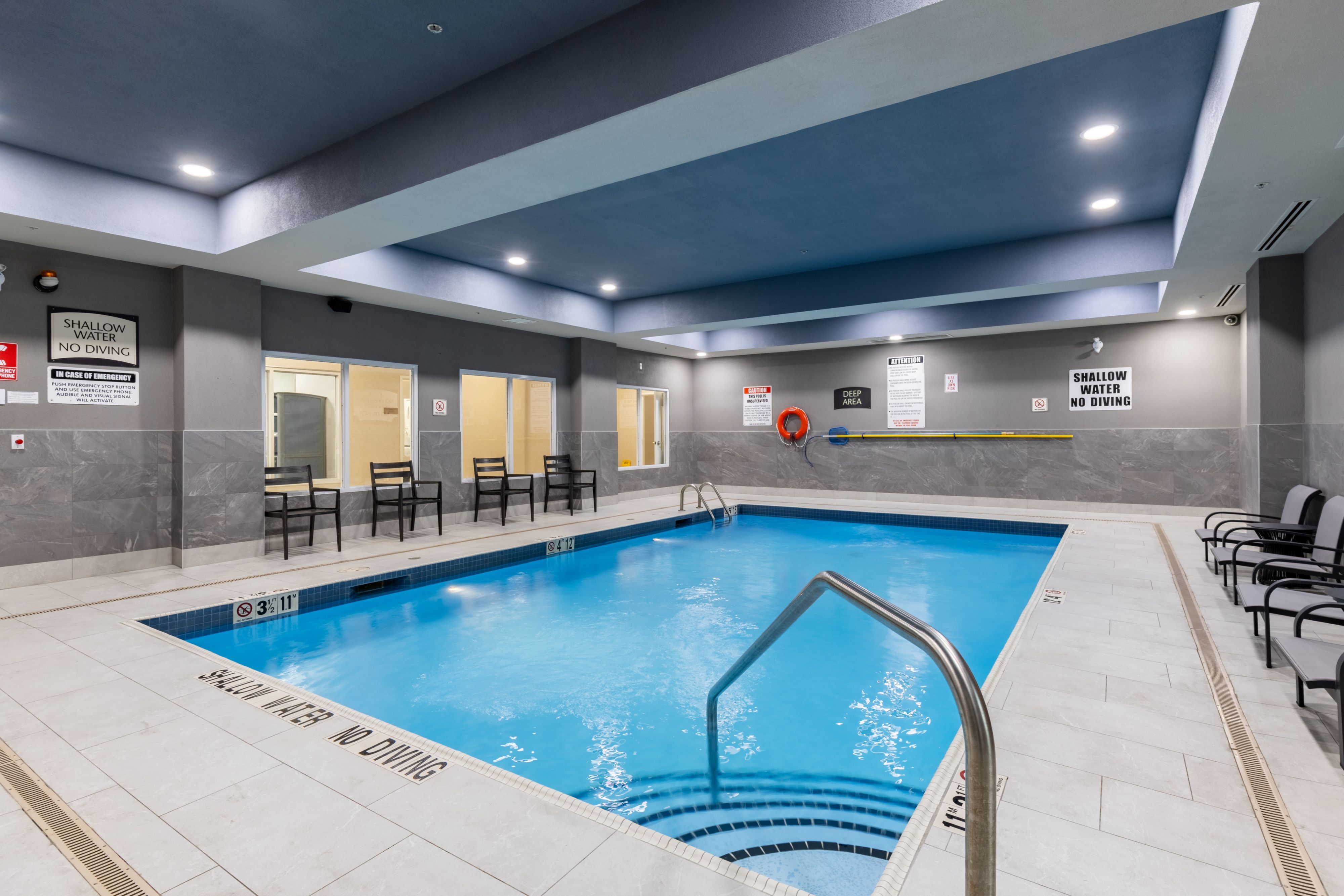 image A sparkling indoor pool area with seating for relaxation and enjoyment.
