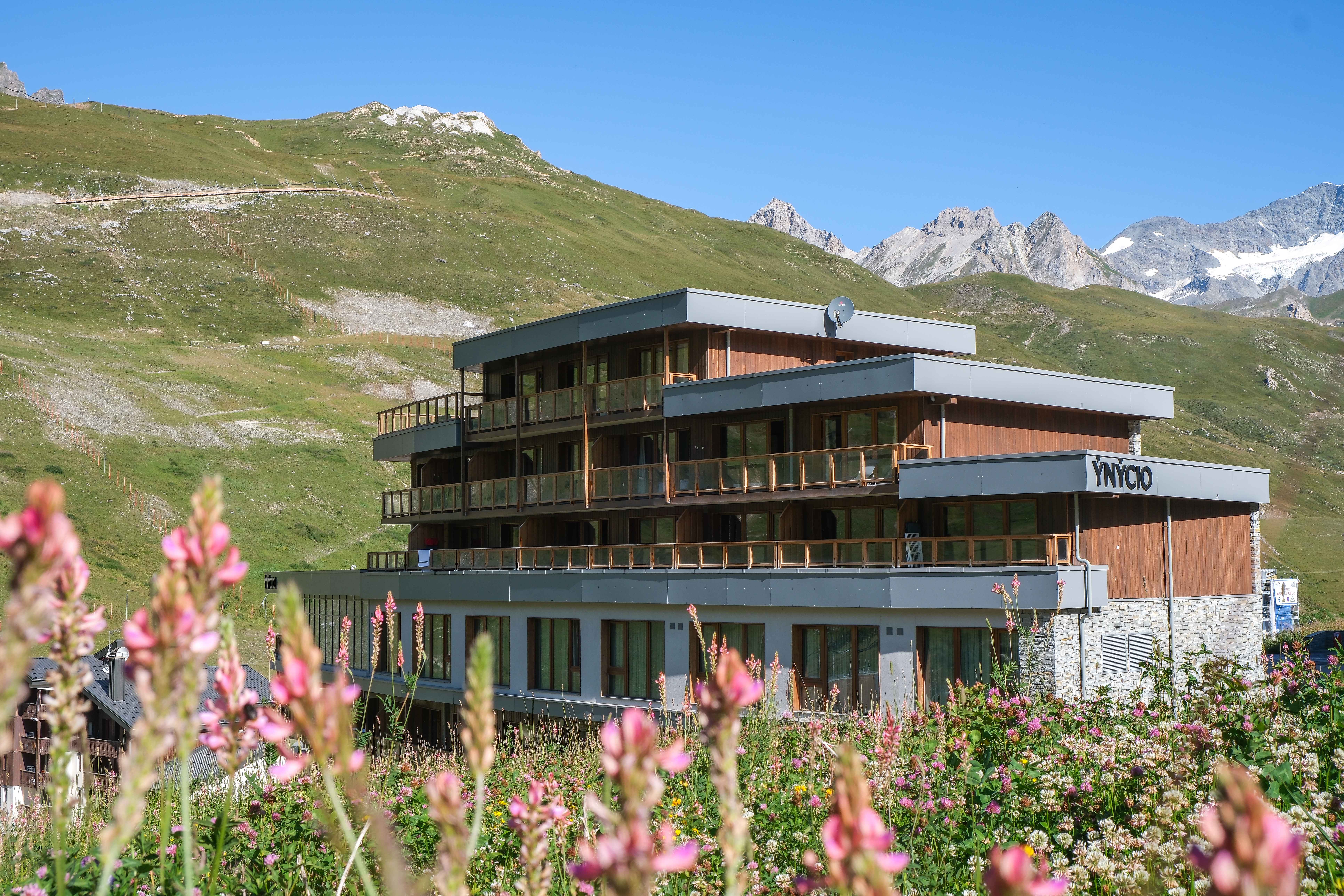 image Alpine wildflowers frame the entrance in summer, with the resort sitting at 2,150m above sea level