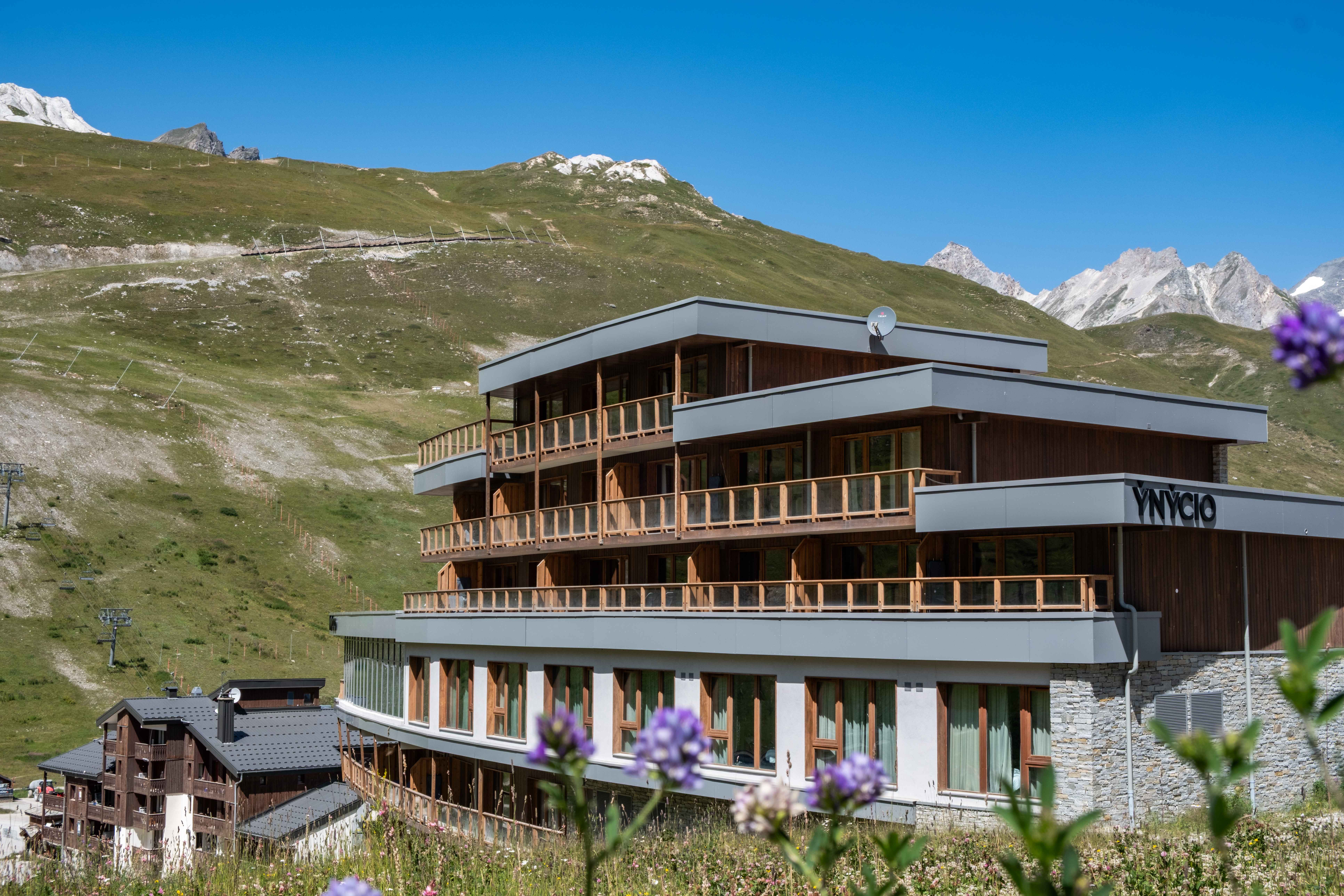 image Wood-clad façade and stacked balconies overlooking the green slopes of Tignes Val Claret