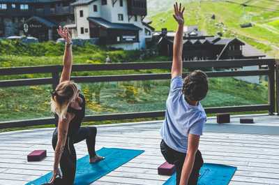 The residence terrace at 2,300m —yoga, fresh mountain air, and the Belleville Valley peaks in every direction.