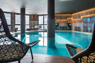 The indoor pool, with large windows facing the snow-covered mountains.