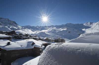 Winter sun over the snow, with the ski area just beyond.