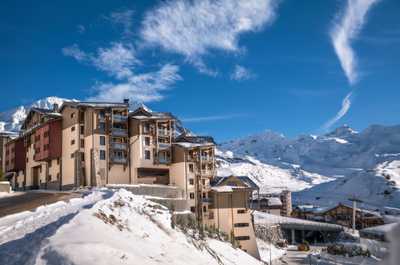 Fresh snow settled on the mountainside buildings in winter.