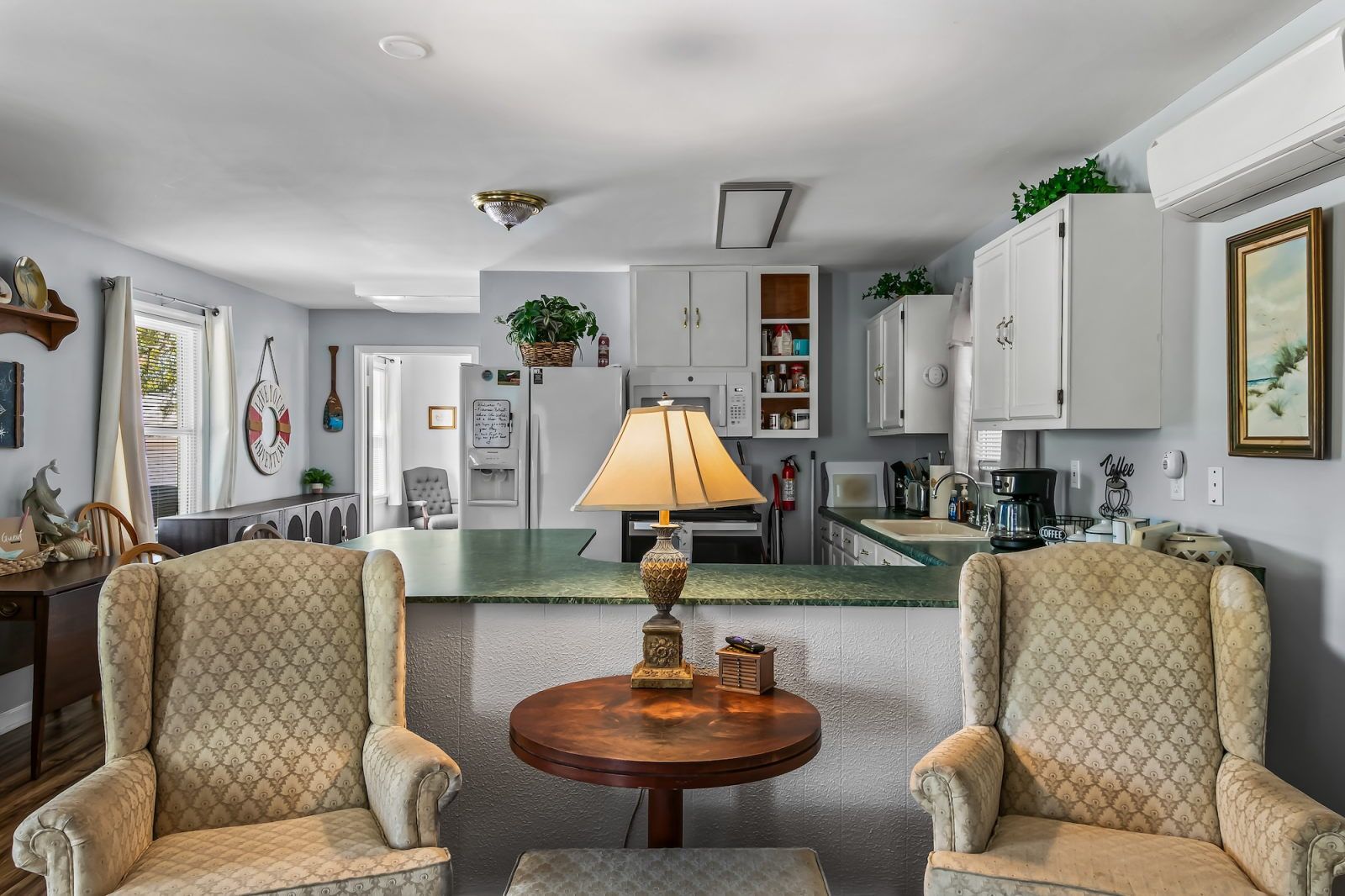 image Living space with two plush armchairs and warm wall tones — a quiet spot to decompress after a day on the Gulf