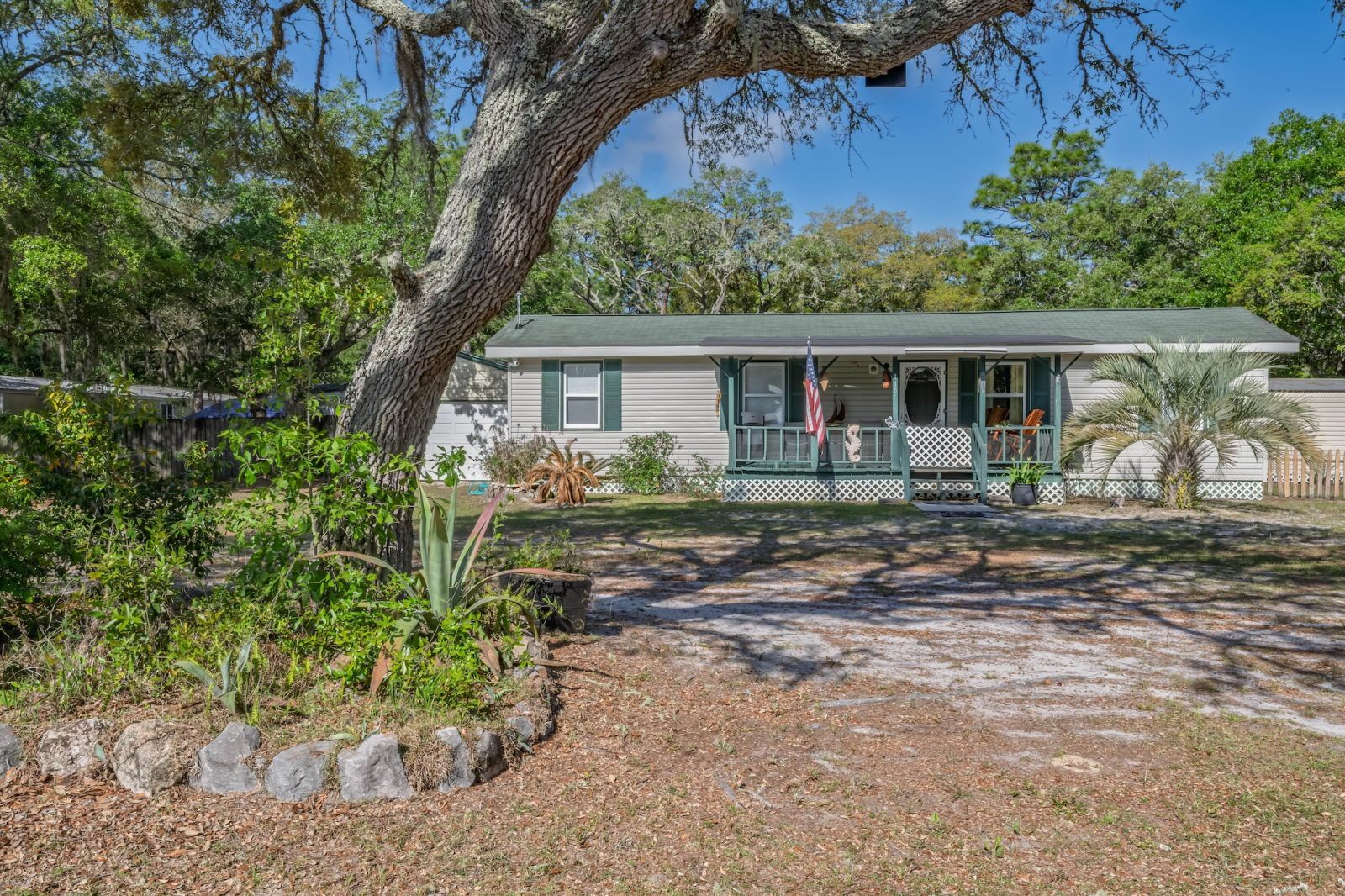 image Shaded front yard framed by tall trees and a wide lawn — your pets have plenty of room to roam