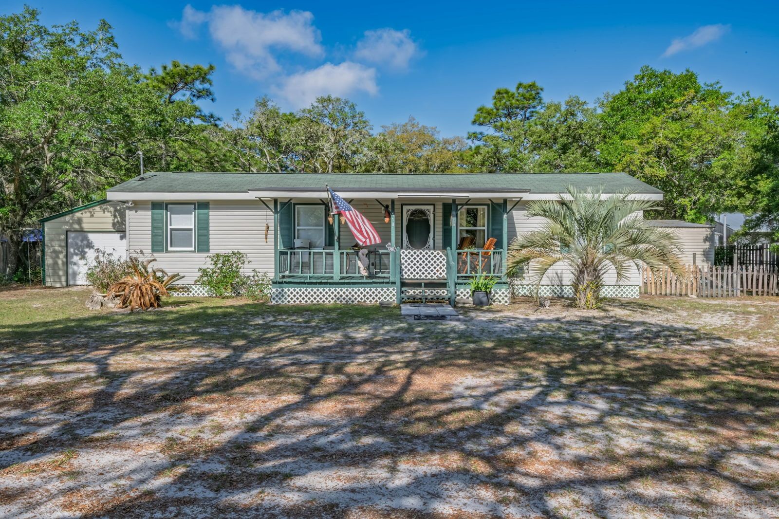image Front porch with rocking chairs and a welcoming flag — settle in and listen to the neighbourhood settle down around you