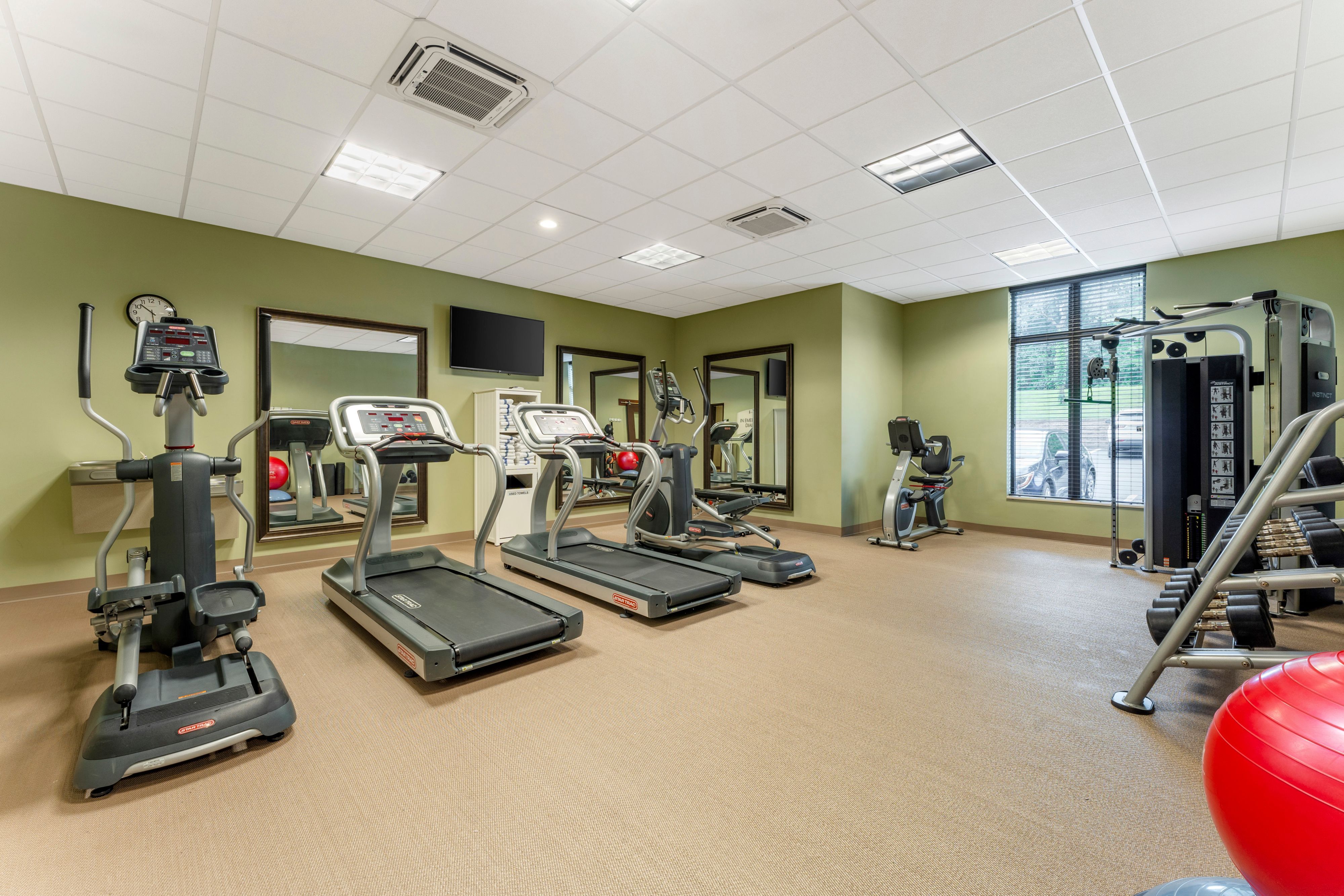 image Spacious gym with a variety of modern fitness machines and natural light.