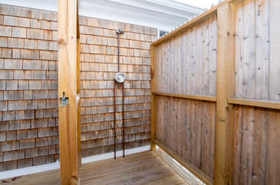 The outdoor shower is perfectly designed for rinsing off after a day at the beach.