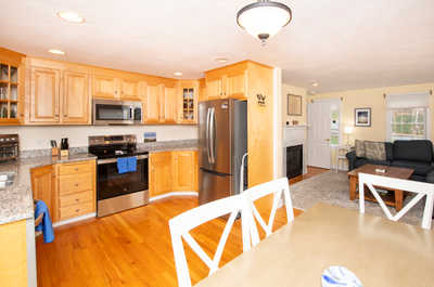 Enjoy family meals at the dining table with a cozy view of the living space, perfect for gathering.