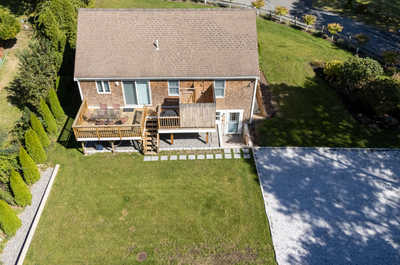Enjoy outdoor dining on the spacious deck, with steps down to a large, open backyard.