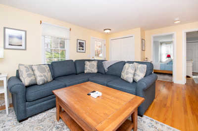 Relax in the cozy living area, where soft cushions invite you to unwind and enjoy a movie night.