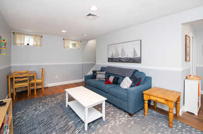 Gather around in the cozy den, featuring a comfortable sofa and playful décor.