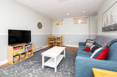 Unwind in this relaxed living area, complete with a vibrant couch and games ready for family fun.