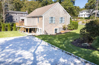 Relax in the lush backyard, surrounded by greenery and cozy corners perfect for outdoor gatherings.