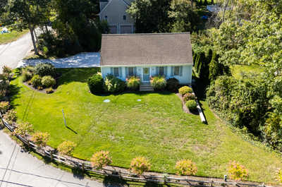 Relax in the lush green yard, surrounded by vivid blooms and natural beauty.