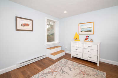 A charming space awaits, showcasing a playful décor with a lovely window inviting the sunshine in.