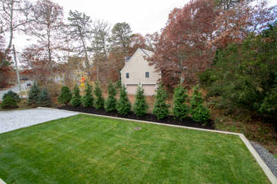 Bask in the serenity of the lush backyard, surrounded by vibrant autumn foliage.