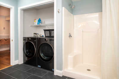 Effortlessly manage your laundry with modern appliances and a handy shower for quick refreshes.