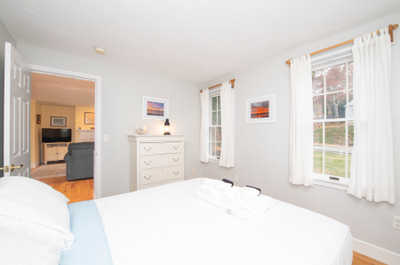 Rest and recharge in this cozy bedroom featuring soft linens and natural light streaming through large windows.
