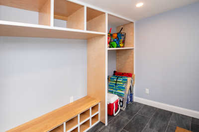 Find the perfect spot to stash beach gear and toys in this organized storage area.