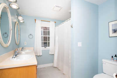 Refresh in the serene bathroom with dual sinks, natural light, and a soothing color palette.