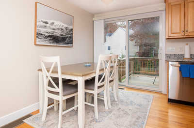 Gather around the dining table, adorned with simple décor, and enjoy moments together in a welcoming space.