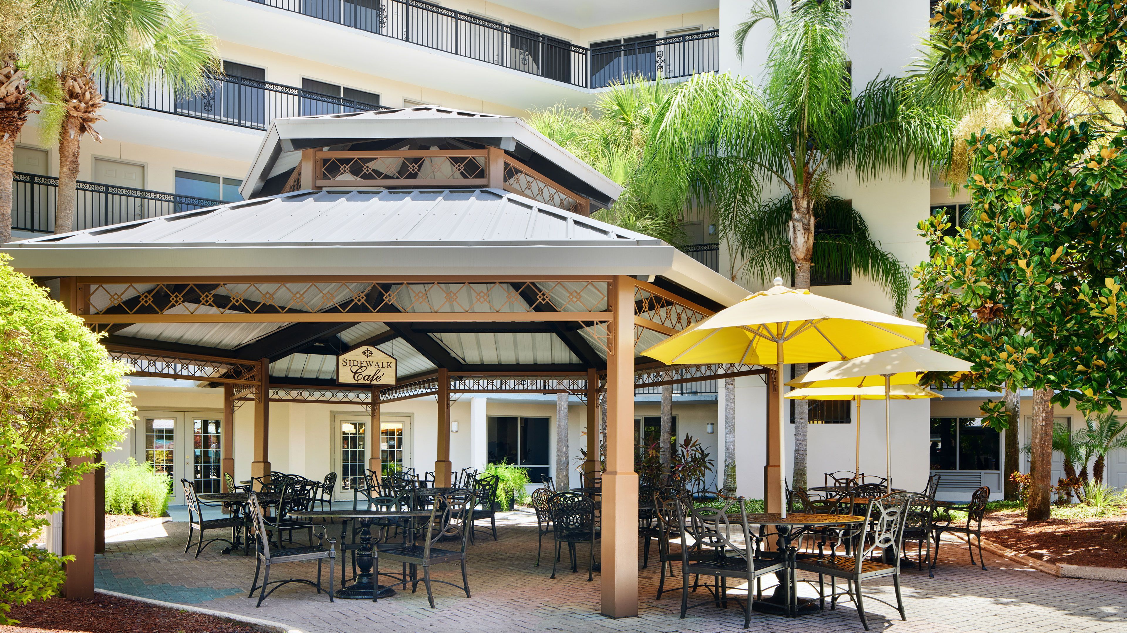 image Outdoor seating under a shaded gazebo with tables.