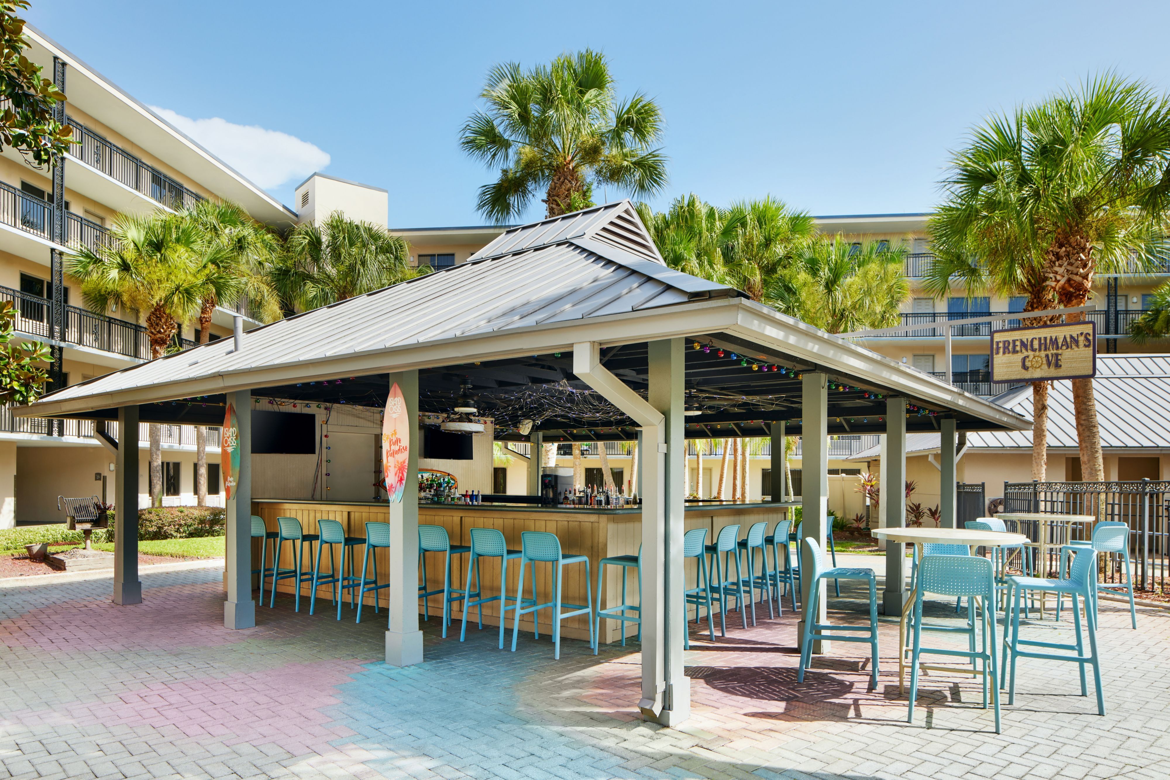 image Outdoor bar area with colorful stools.