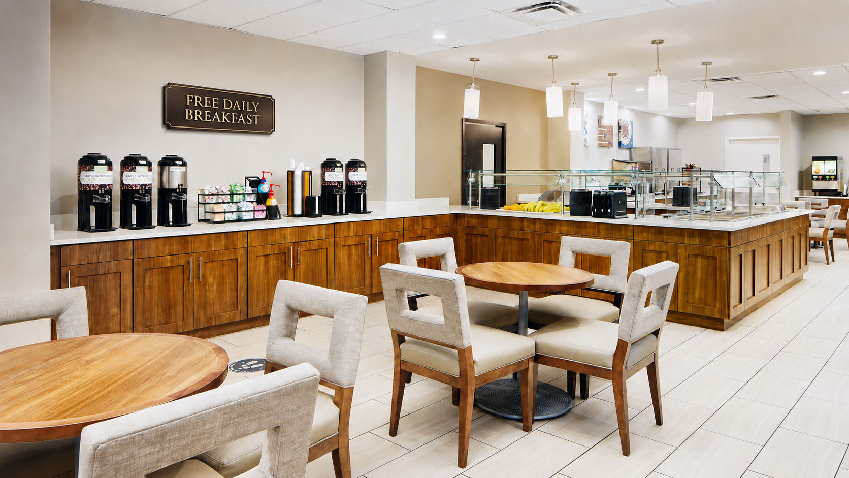 image Complimentary breakfast display with coffee machines and a selection of pastries.