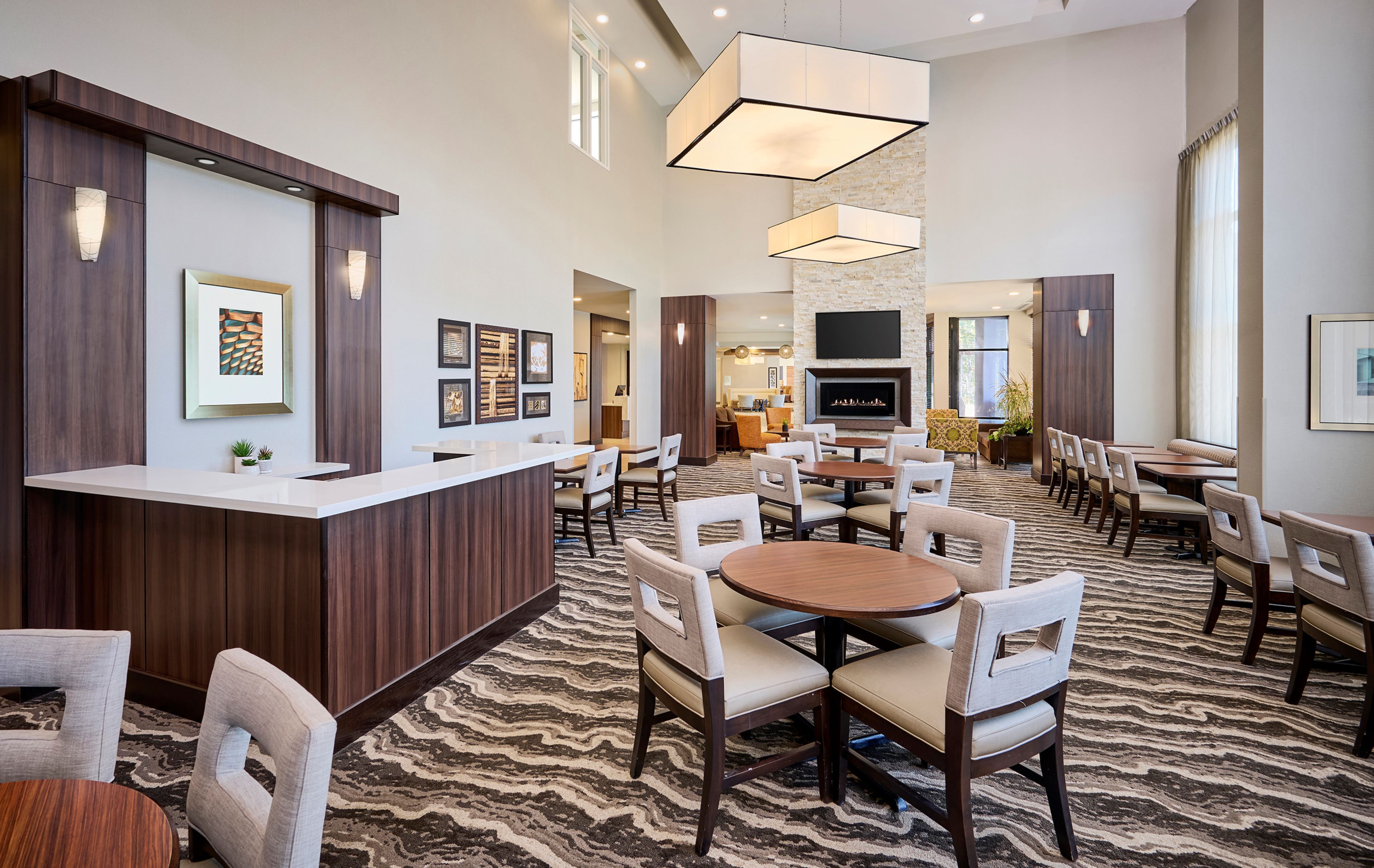 image Open common area with lounge furniture and tables.