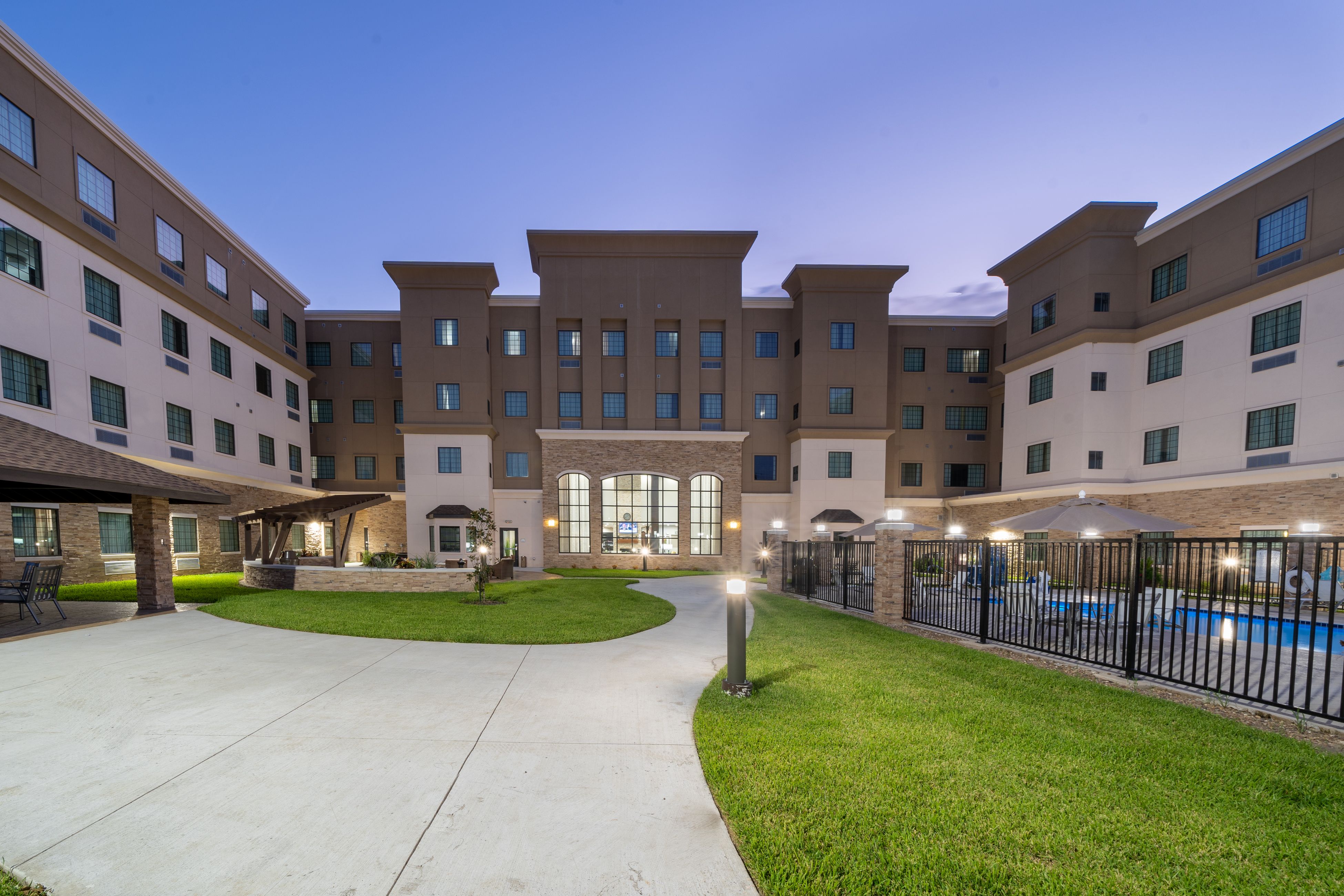 image Stroll through the beautifully landscaped courtyard, where relaxation meets elegance.