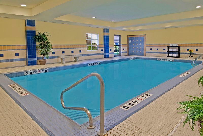 image Indoor pool with clear water, non-slip tiling, and natural window light.