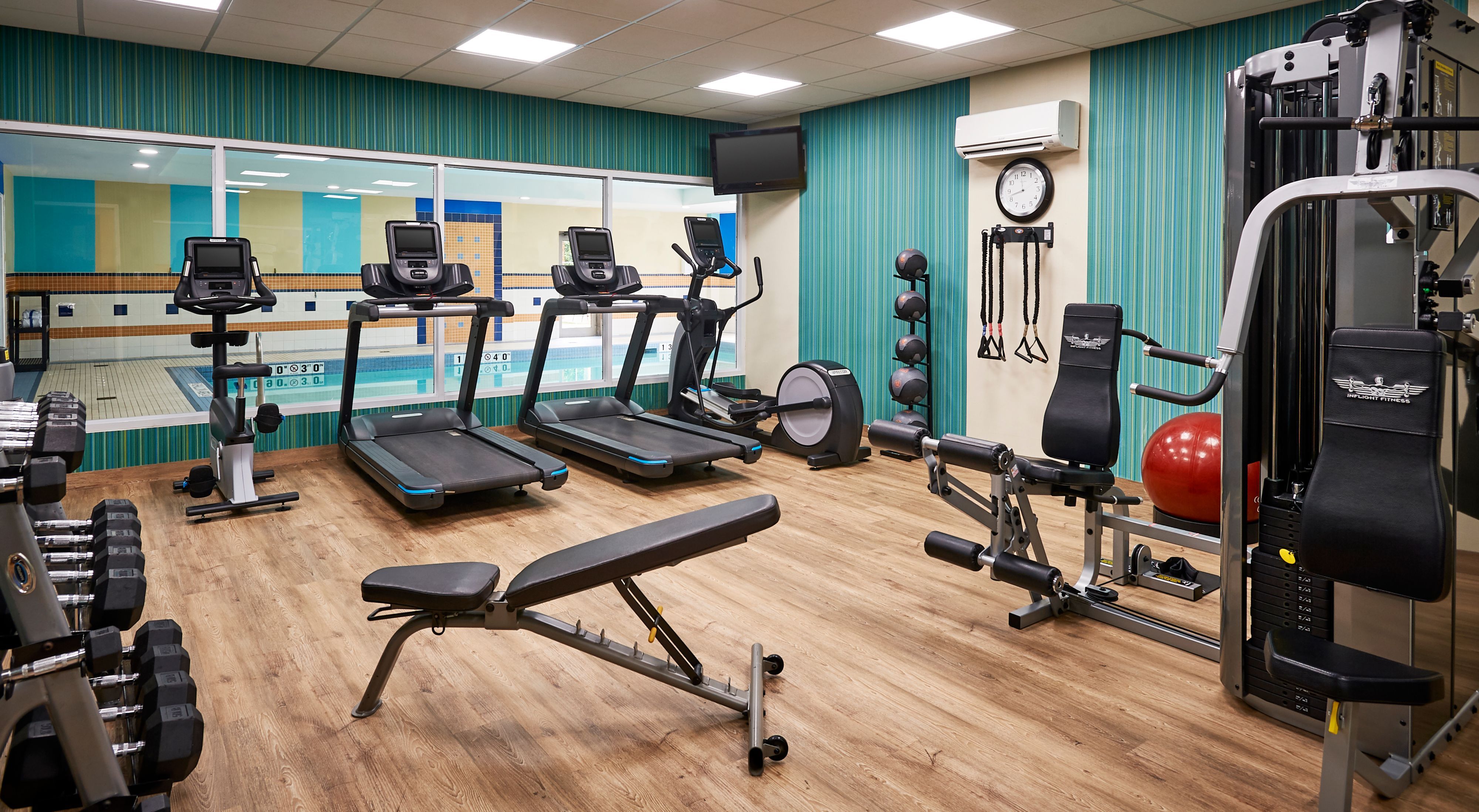 image Well-equipped fitness centre with treadmills, weights, and exercise machines.