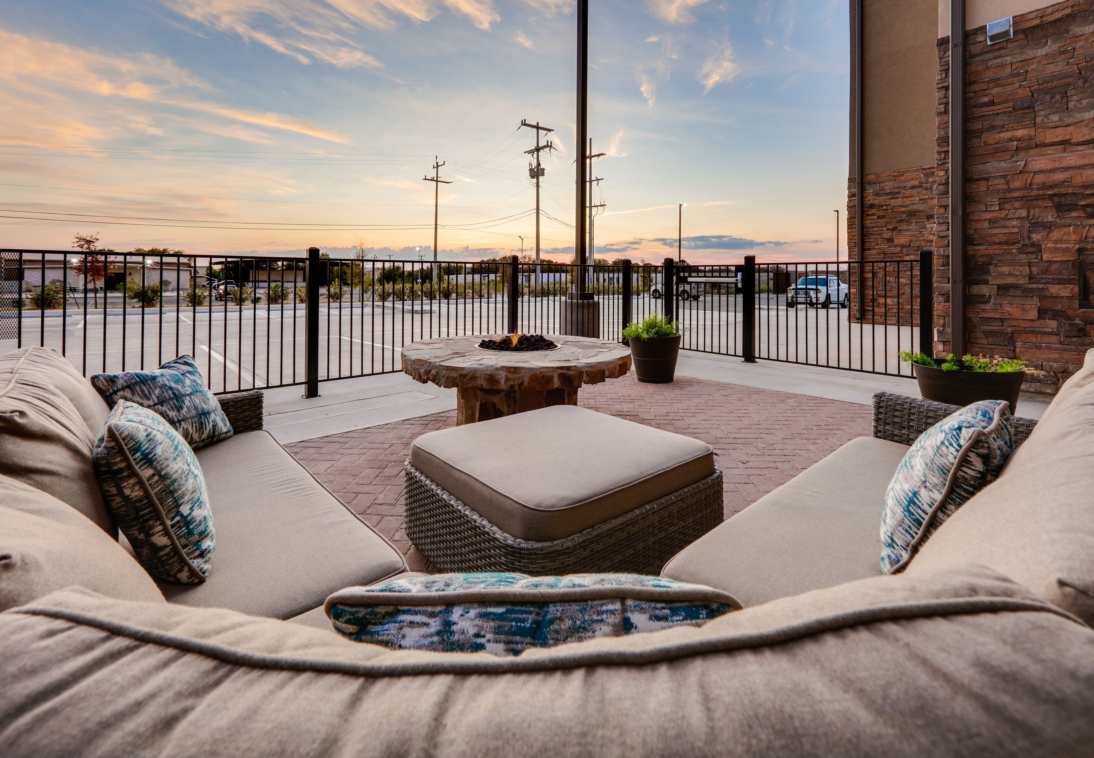 image Comfortable outdoor seating surrounding a fire pit with a scenic view.