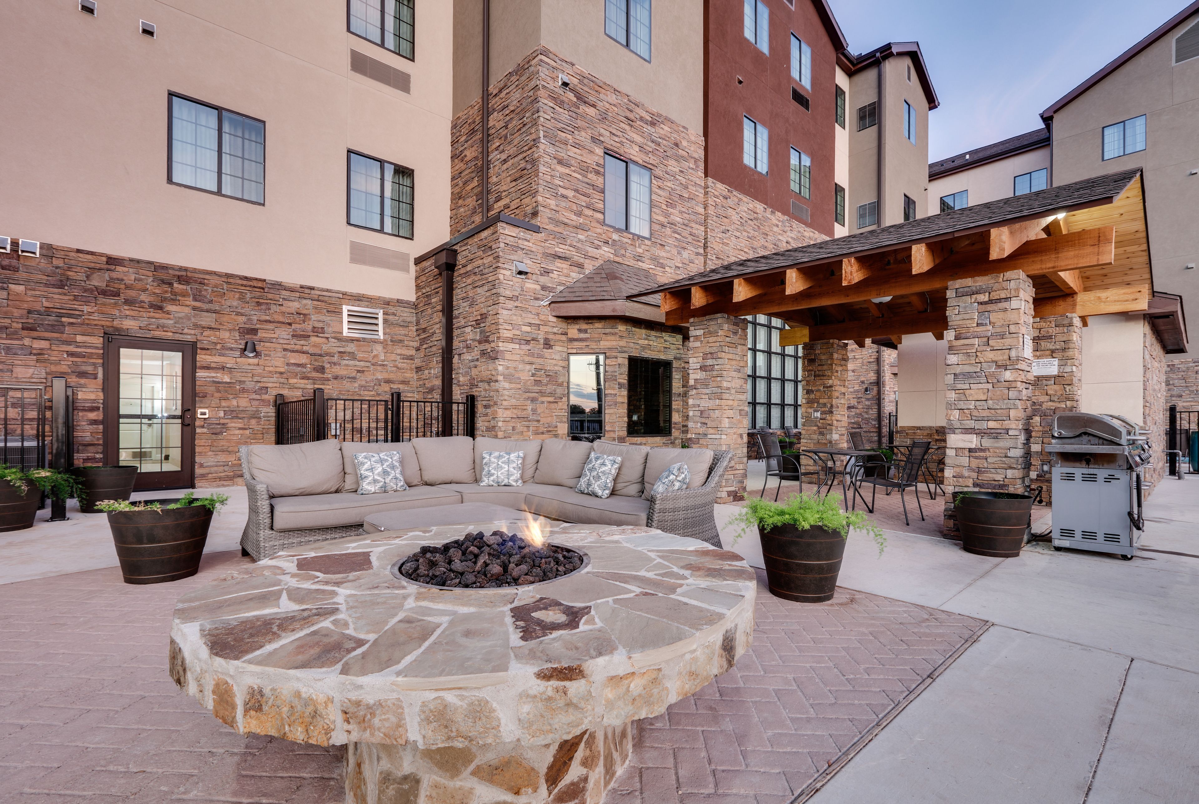 image Cozy seating surrounds a fire pit in a welcoming outdoor space.
