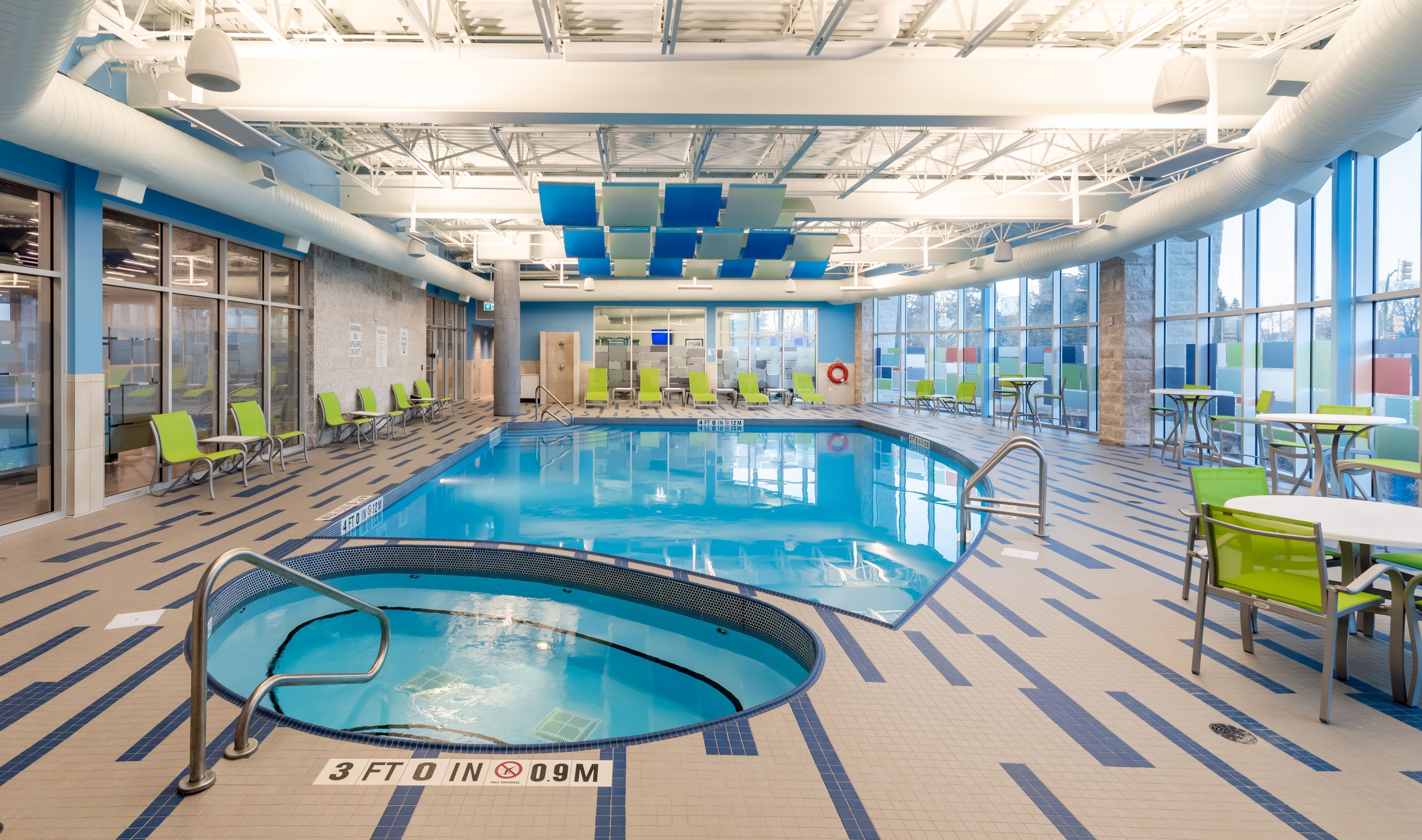 image Bright indoor pool area with ample seating and natural light.