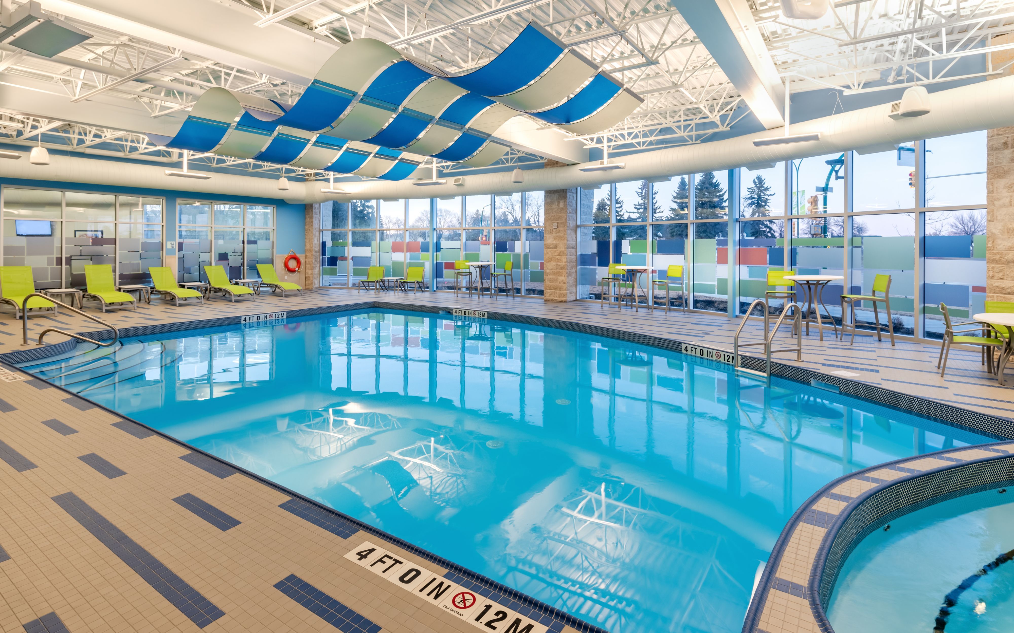 image Indoor pool with colorful decor and comfortable lounge areas.