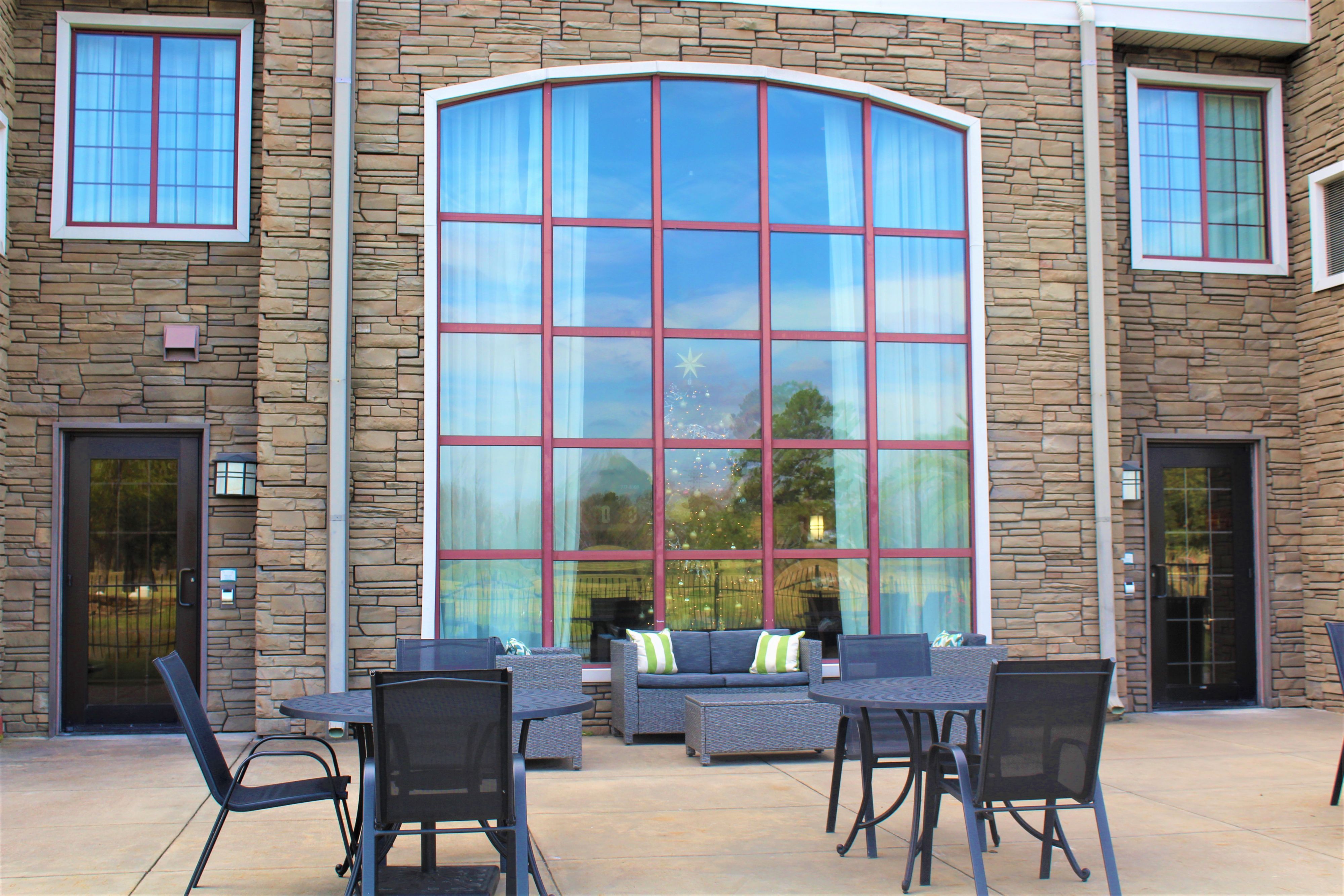 image Outdoor seating area with comfortable furniture and greenery.