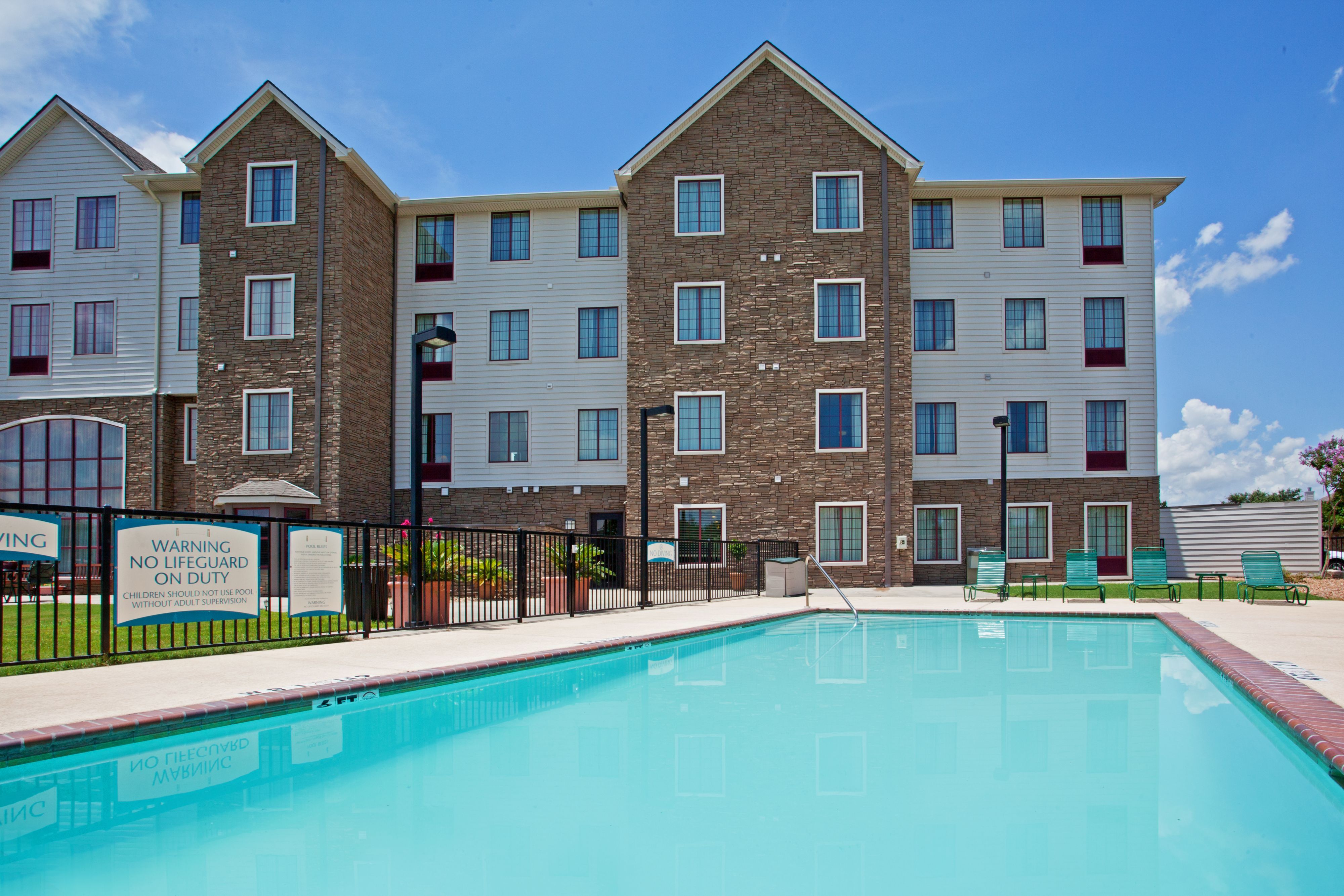 image Outdoor pool with lounge seating for a perfect sunny day.