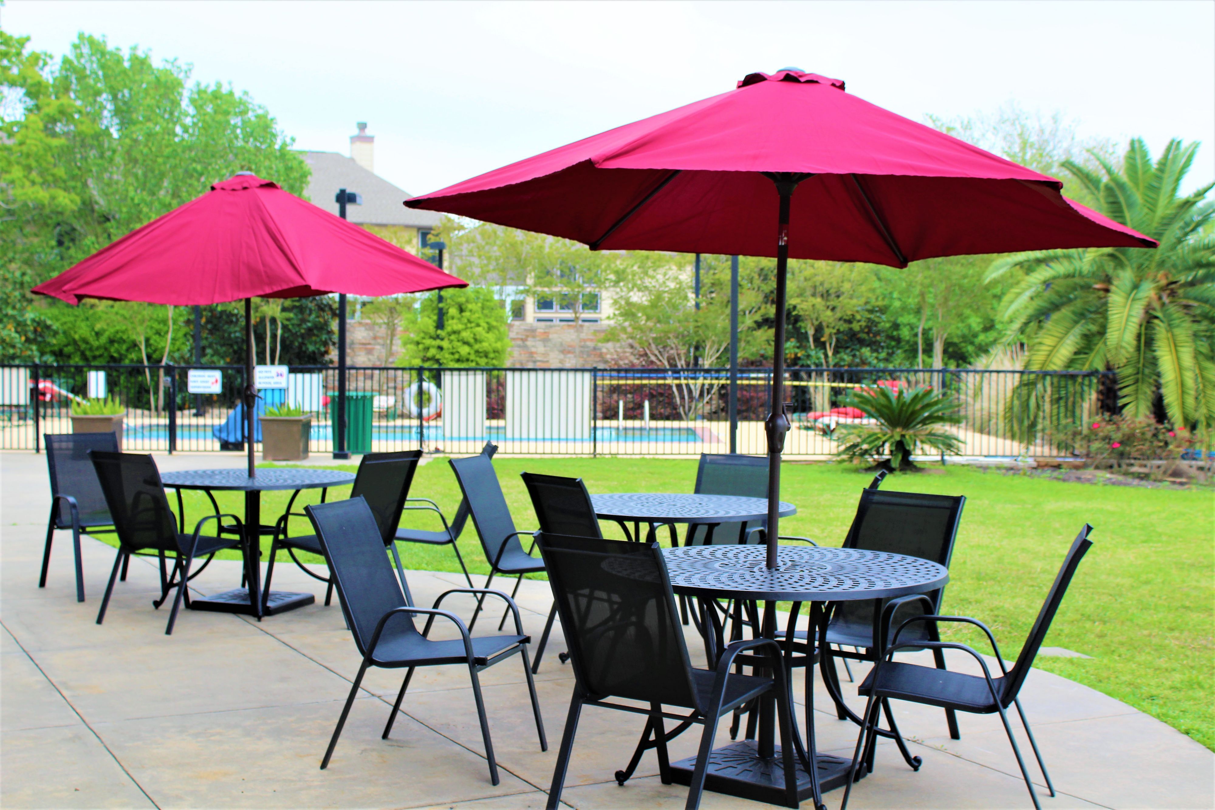 image Outdoor tables with umbrellas for alfresco gatherings.