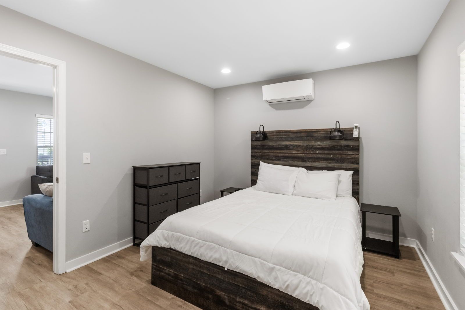 image Step into this cozy bedroom, featuring a plush bed and modern decor for a restful night.
