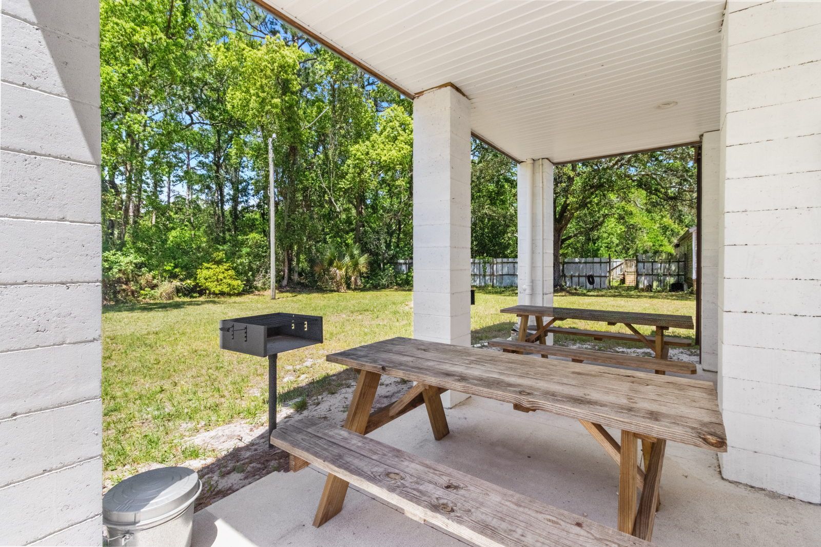 image Unwind in the outdoor space with picnic tables, ideal for friendly BBQs or casual gatherings.