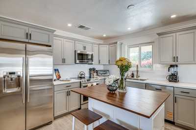 Bright and functional kitchen awaits, perfect for whipping up meals with modern appliances and a cozy dining nook.