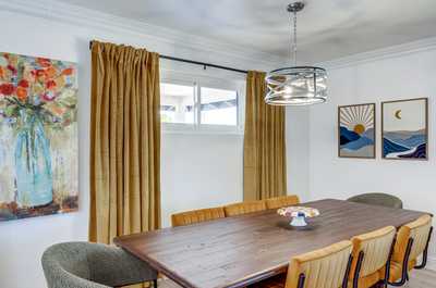 Gather around the elegant dining table, accented by art and mood lighting, for memorable meals together.