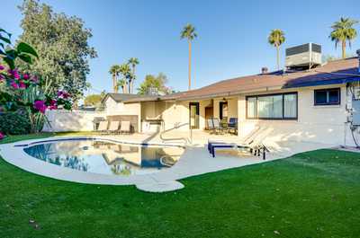 Gather around the pool area, where comfort meets vibrant greenery in a cozy setting.