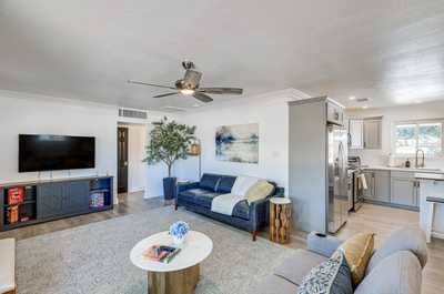 Gather with friends and family in this stylish living space, featuring a sleek kitchen and modern decor.