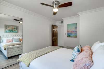 Unwind in a bright, airy room featuring plush pillows and an inviting atmosphere for restful nights.