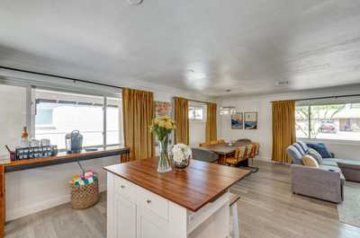 Light streams through the window to illuminate the cozy dining area, a great spot for shared meals.