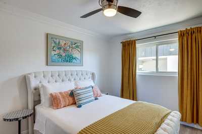 Unwind in this inviting bedroom, complete with soft linens and charming decorative touches.